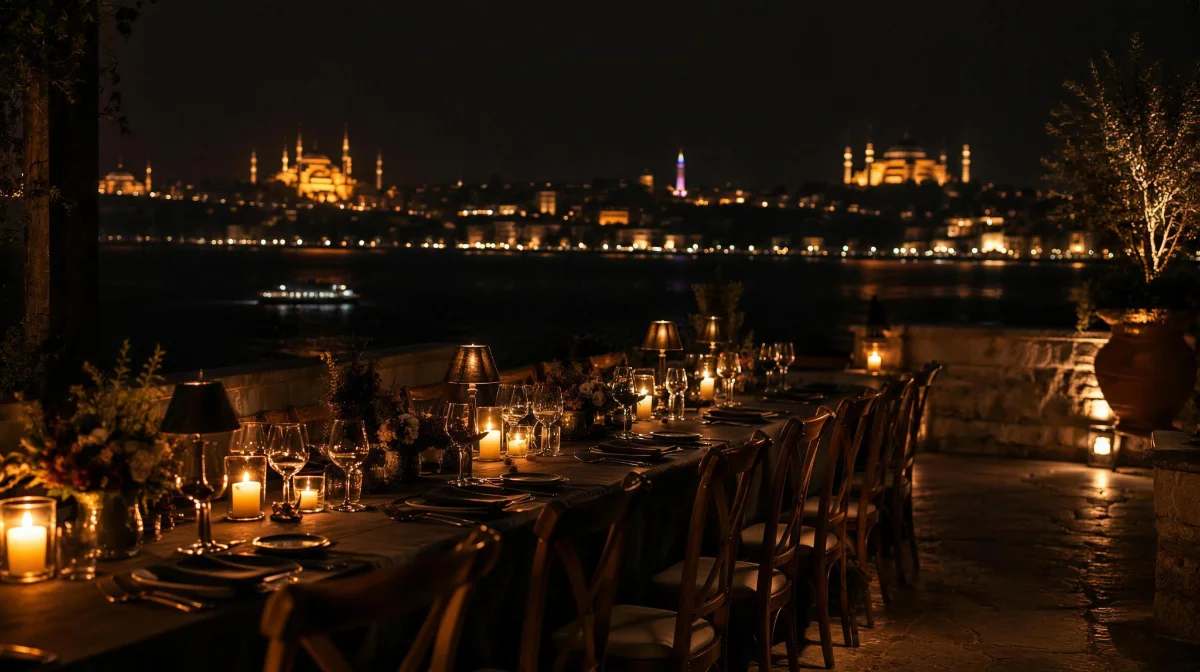 A long candlelit table on a terrace above the Bosphorus at night.
